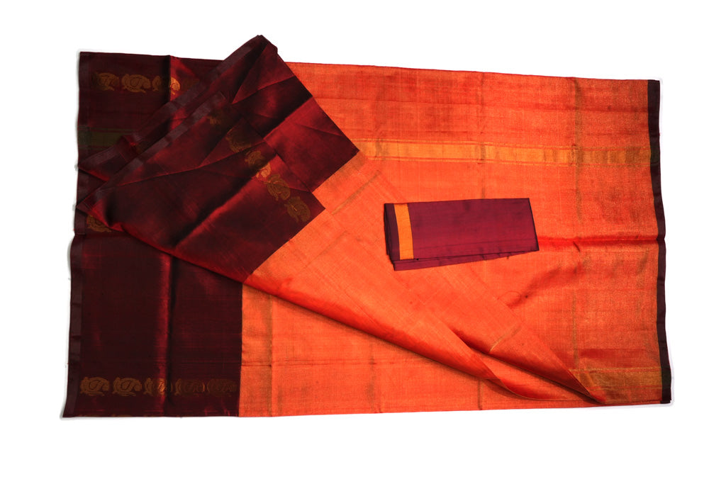 Close-up of maroon designer pallu and zari border on orange Uppada saree