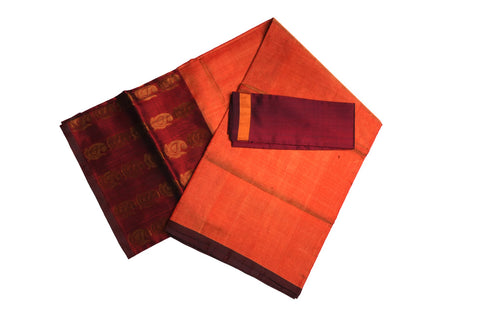 Folded orange Uppada Pattu saree showing maroon zari border and pallu